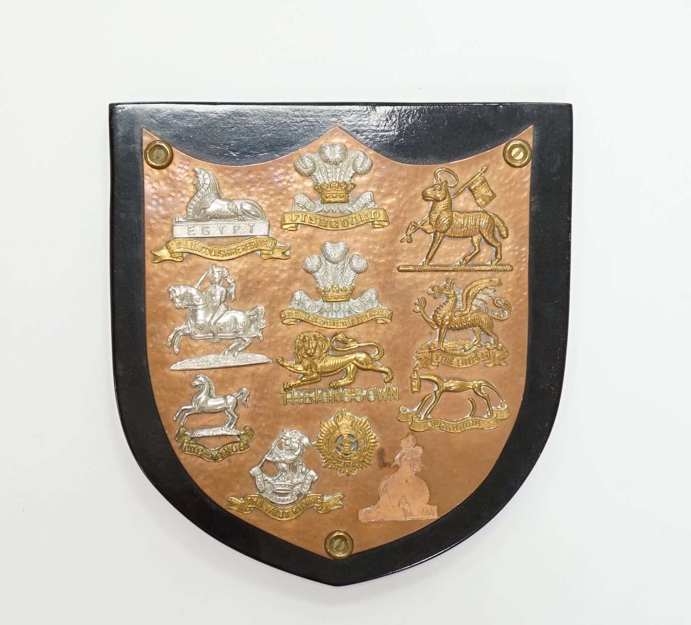 A collection of Military cap badges and buttons